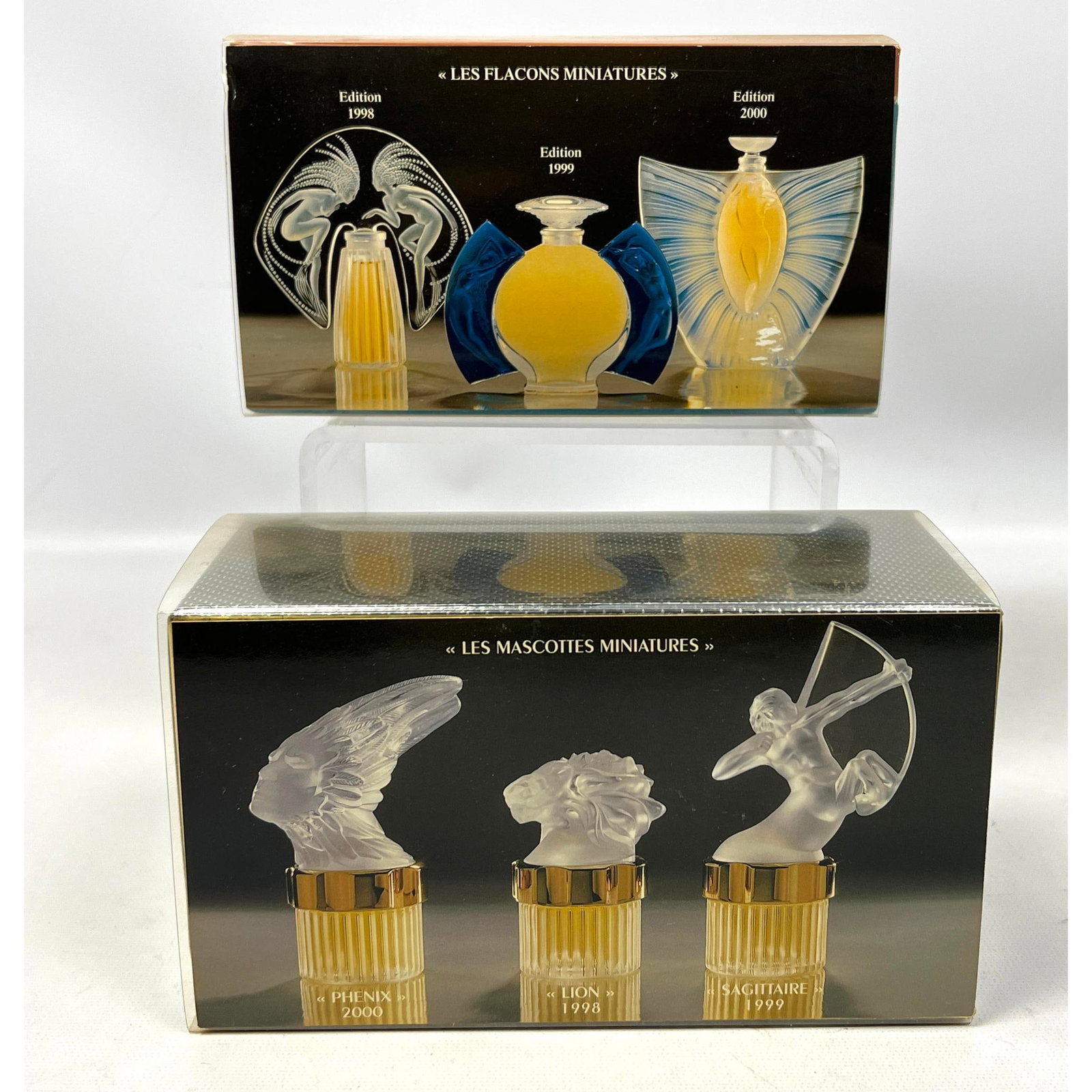 Boxed Miniature Lalique Perfume Bottles. 1998, 1999, 2000 Plastic tops.: Boxed Miniature Lalique Perfume Bottles. 1998, 1999, 2000 Plastic tops. Dimensions: Height: 4 inches, Width: 7 inches, Depth: 3.5 inches. --- US Packing and Shipping charge: In house shipping availabl