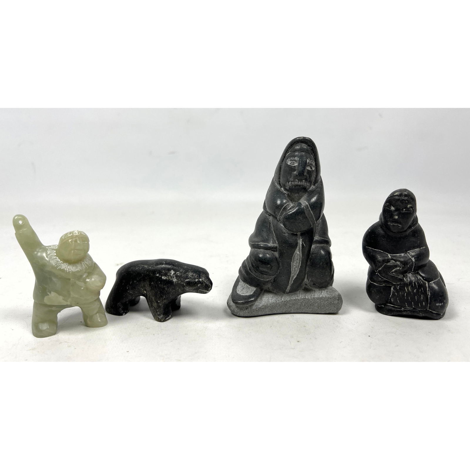 4pc Canada Eskimo Carved Stone Figures. Three Eskimo figures; One bear. Two have paper labels.  sign (1 of 15)