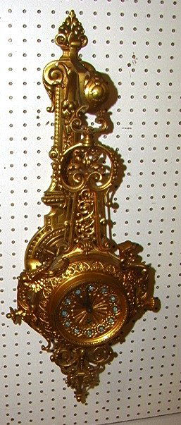 Gilt Bronze Pendant Wall Clock. Hanging clock on: Gilt Bronze Pendant Wall Clock. Hanging clock on wall mount bracket.-- Dimensions: H: 30 inches: W: 11 inches: D: 8.5 inches ---