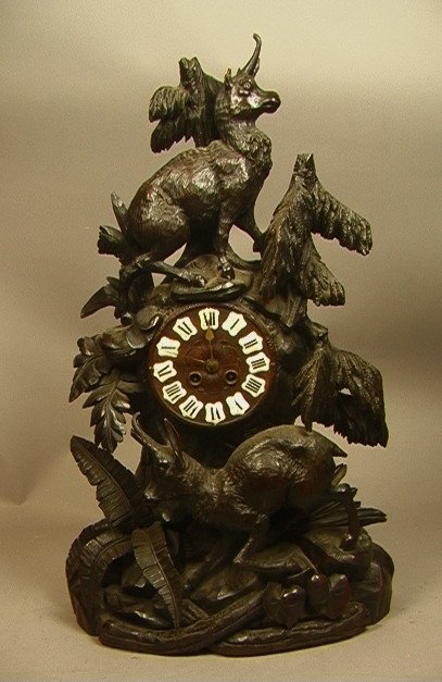 Large Black Forest Carved Wood Clock. Enamel num: Large Black Forest Carved Wood Clock. Enamel numbers. -- Dimensions: H: 25.5 inches: W: 16 inches: D: 7.5 inches ---