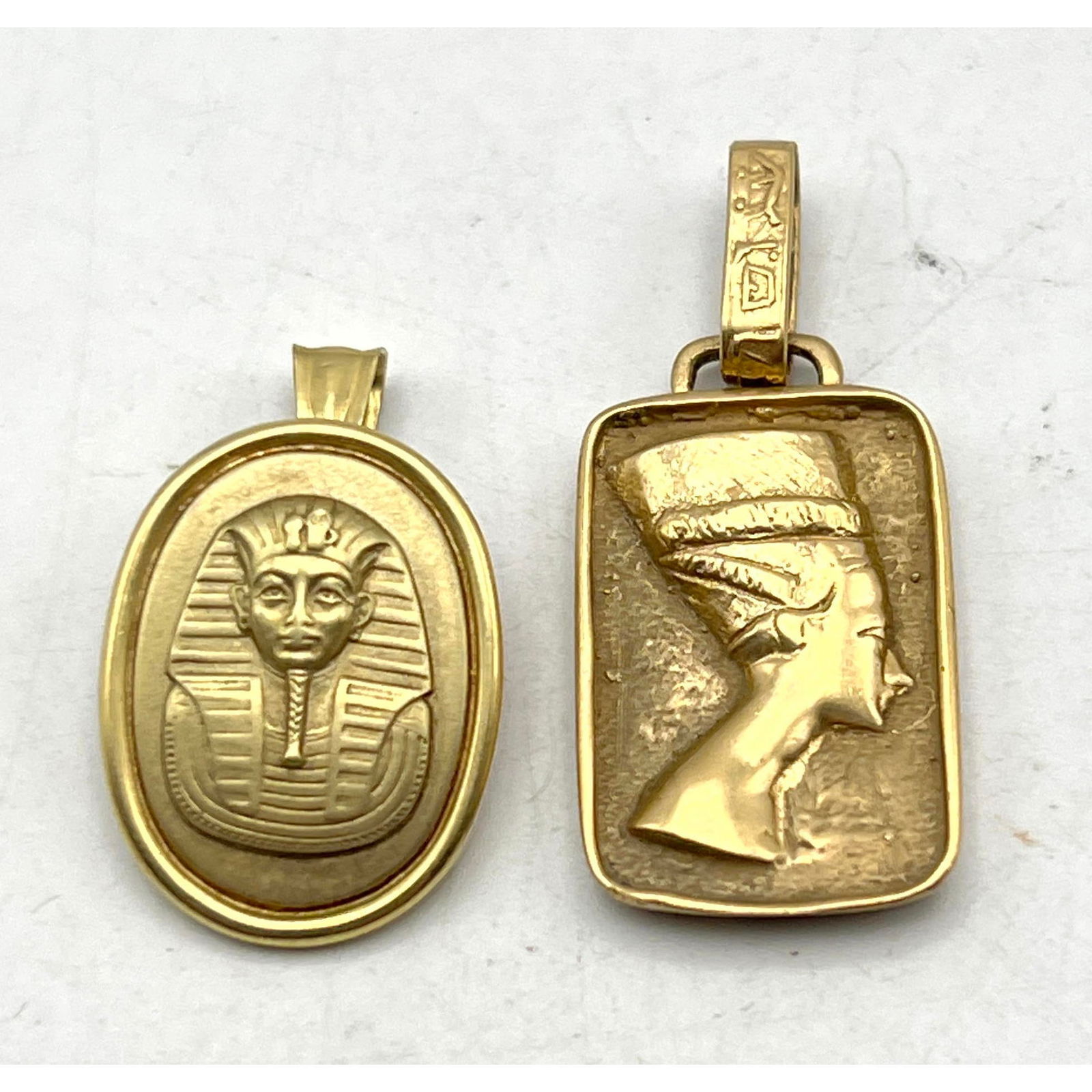2pc 14K Gold Egyptian Pendants. 1) Nefertiti head with hieroglyphs on bale; marked 14K. 2) King Tut (1 of 11)