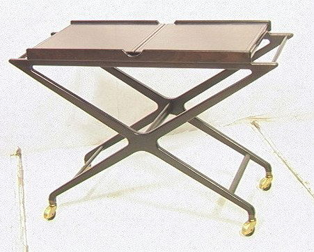 BAKER Ebonized Wood Rolling Tea Bar Cart. Two hin: BAKER Ebonized Wood Rolling Tea Bar Cart. Two hinged tops fold out to expose white Formica tops. "X" base on four casters. Metal label.-- Dimensions: H: 29 inches: W: 43 inches: D: 18.5 inches ---