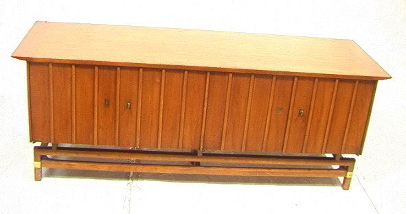 American Modern Walnut Sideboard Credenza. Asian: American Modern Walnut Sideboard Credenza. Asian style with brass mounts and leg accents. Unmarked.-- Dimensions: H: 26 inches: D: 22 inches: L: 70 inches ---