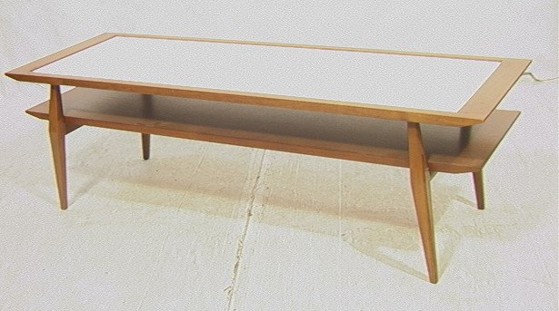 Bertha Schaeffer Coffee Cocktail Table. M. Singe: Bertha Schaeffer Coffee Cocktail Table. M. Singer and Sons Lable. White laminate top on walnut frame. Two tier with beveled edge.-- Dimensions: H: 17 inches: W: 56 inches: D: 19 inches ---
