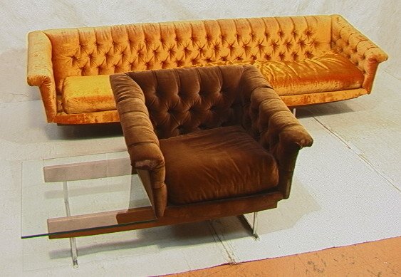 MILO BAUGHMAN style Chair and Sofa. Glass End Tab: MILO BAUGHMAN style Chair and Sofa. Glass End Table connected to Chair. Tubular chrome legs with wood detail. Tapered arms. Tufted upholstery. -- Dimensions: H: 27 inches: D: 32 inches: L: 104 inches 