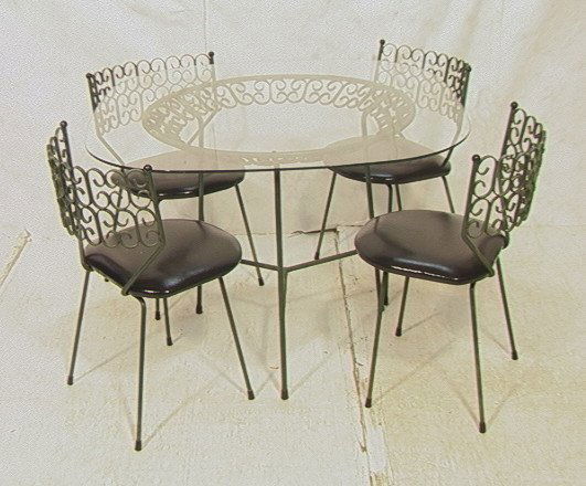 5pc SALTERINI Iron Cafe Set. Table & 4 Chairs. Pat: 5pc SALTERINI Iron Cafe Set. Table & 4 Chairs. Patio outdoor table with glass top. 4 chairs with black seat cushions. Unmarked.-- Dimensions: H: 29 inches: W: 42 inches: D: 42 inches ---