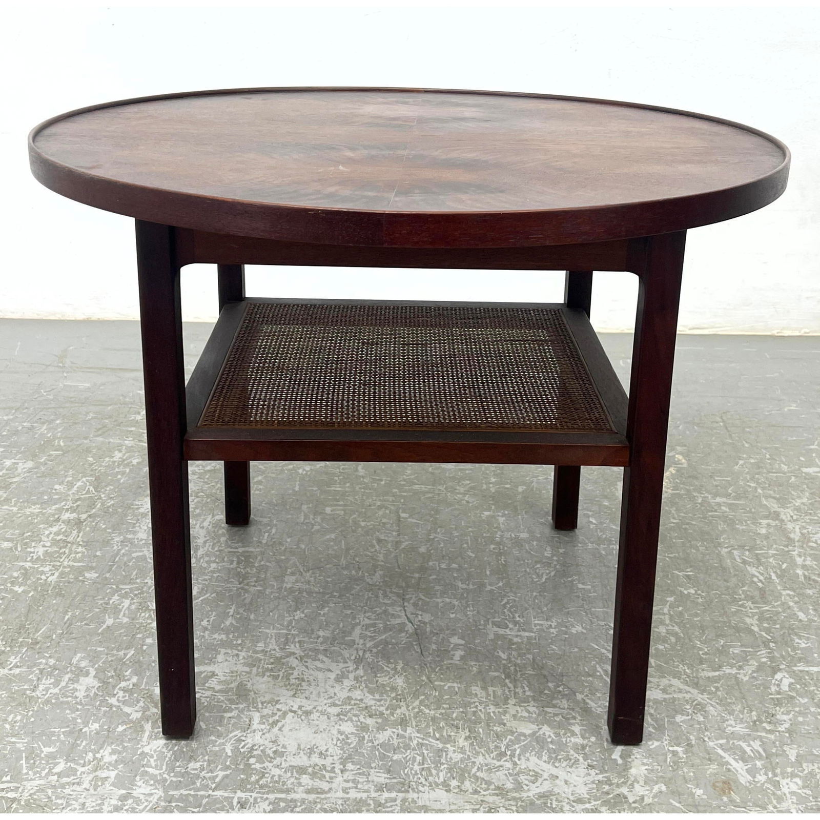 Mid Century Round Side End Table with Cane Shelf Jack Cartwright style. Unsigned.: Mid Century Round Side End Table with Cane Shelf Jack Cartwright style. Unsigned. Dimensions: Height: 20.5 inches, Width: 27 inches, Depth: 27 inches. --- - - We offer curbside delivery to NYC, Manhat