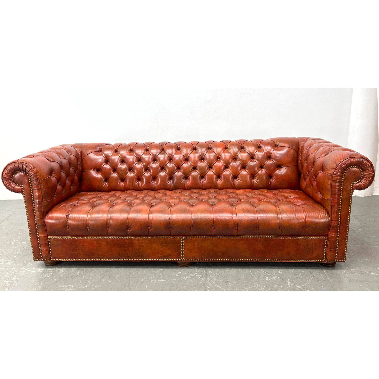 Chesterfield style Tufted Leather Sofa. Wood bun feet. Brass tack trim. (1 of 10)