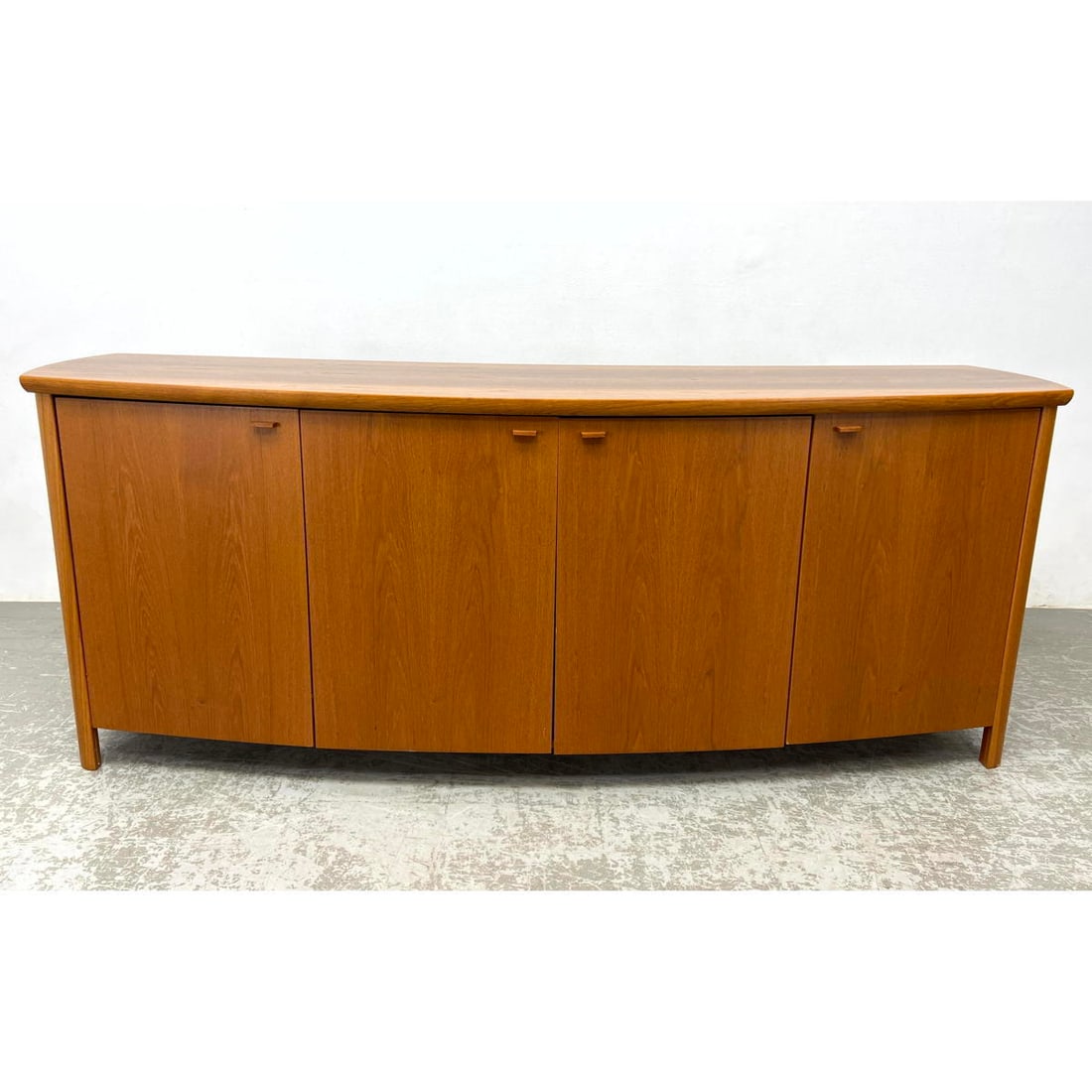 SKOVSBY Danish Modern Teak Credenza. Bowed facade. Model SM804T. Label.: SKOVSBY Danish Modern Teak Credenza. Bowed facade. Model SM804T. Label. Dimensions: Height: 33 inches, Width: 83.5 inches, Depth: 22.5 inches. --- - We offer curbside delivery for most items to NYC, M