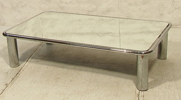 PACE Mirror Top Cocktail Coffee Table. Four Thick: PACE Mirror Top Cocktail Coffee Table. Four Thick chromed steel tubular legs. Rounded edges to table top. -- Dimensions: H: 15 inches: D: 35 inches: L: 62 inches ---