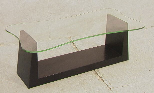 GILBERT ROHDE Style Black Ebonized Cocktail Table: GILBERT ROHDE Style Black Ebonized Cocktail Table. Ebonized base with 1/2" thick glass top. Unmarked. Attribution.-- Dimensions: H: 17.25 inches: W: 49 inches: D: 25 inches ---