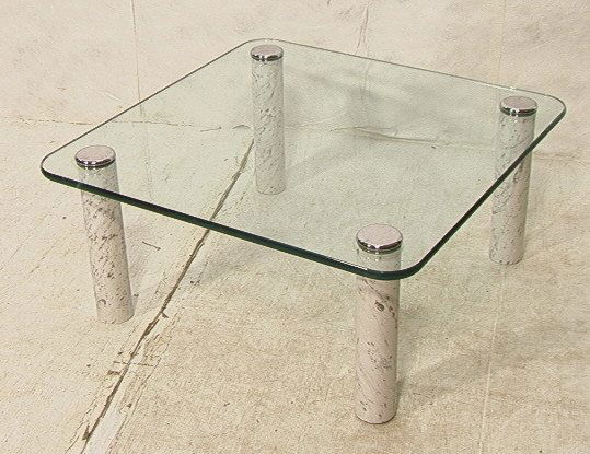 KARL SPRINGER Style Marble and Glass Coffee Table: KARL SPRINGER Style Marble and Glass Coffee Table. 1" Thick glass top over thick round white marble columns. Chrome caps to leg columns. Cocktail Table. Not marked. -- Dimensions: H: 16 inches: W: 36