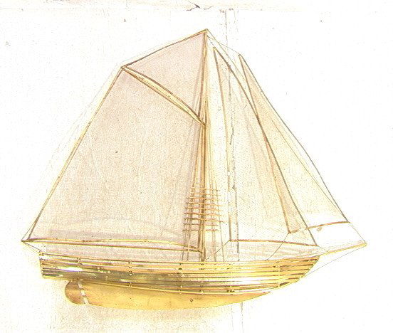 JERE style Brass and Screen Sailboat. Brass frame: JERE style Brass and Screen Sailboat. Brass frame boat with screen sails. Unsigned.-- Dimensions: H: 42 inches: W: 44 inches: D: 5 inches ---