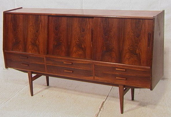 Danish Modern Rosewood Credenza Sideboard. Three: Danish Modern Rosewood Credenza Sideboard. Three sliding doors over six drawers on long tapered legs-- Dimensions: H: 4242.5. inches: D: 18.25 inches: L: 78 inches ---