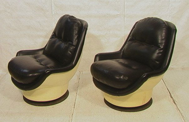 Pair 70's Modern Molded Plastic Lounge Chairs. S: Pair 70's Modern Molded Plastic Lounge Chairs. Swivel and rock. Black vinyl. Space age.-- Dimensions: H: 35.5 inches: W: 35 inches ---