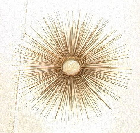 Sunburst Iron Wall Sculpture. Center mirror disk: Sunburst Iron Wall Sculpture. Center mirror disk with radiating rods.-- Dimensions: H: 34 inches ---