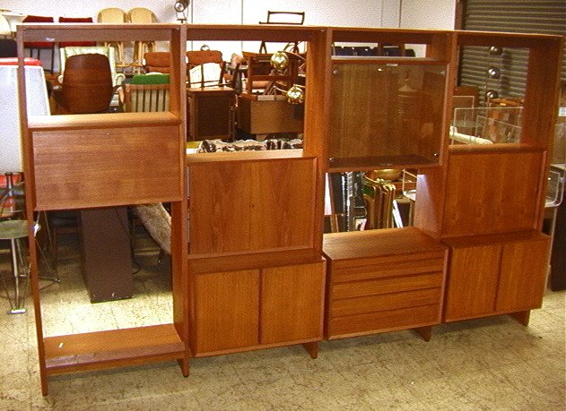 Cado Teak Wall Unit Section. Freestanding. 7 cabi: Cado Teak Wall Unit Section. Freestanding. 7 cabinets. One is a desk, one three drawers, one with glass doors. In order to use Desk portions with this unit, dowels sawn off the back. See pics..-- Dime