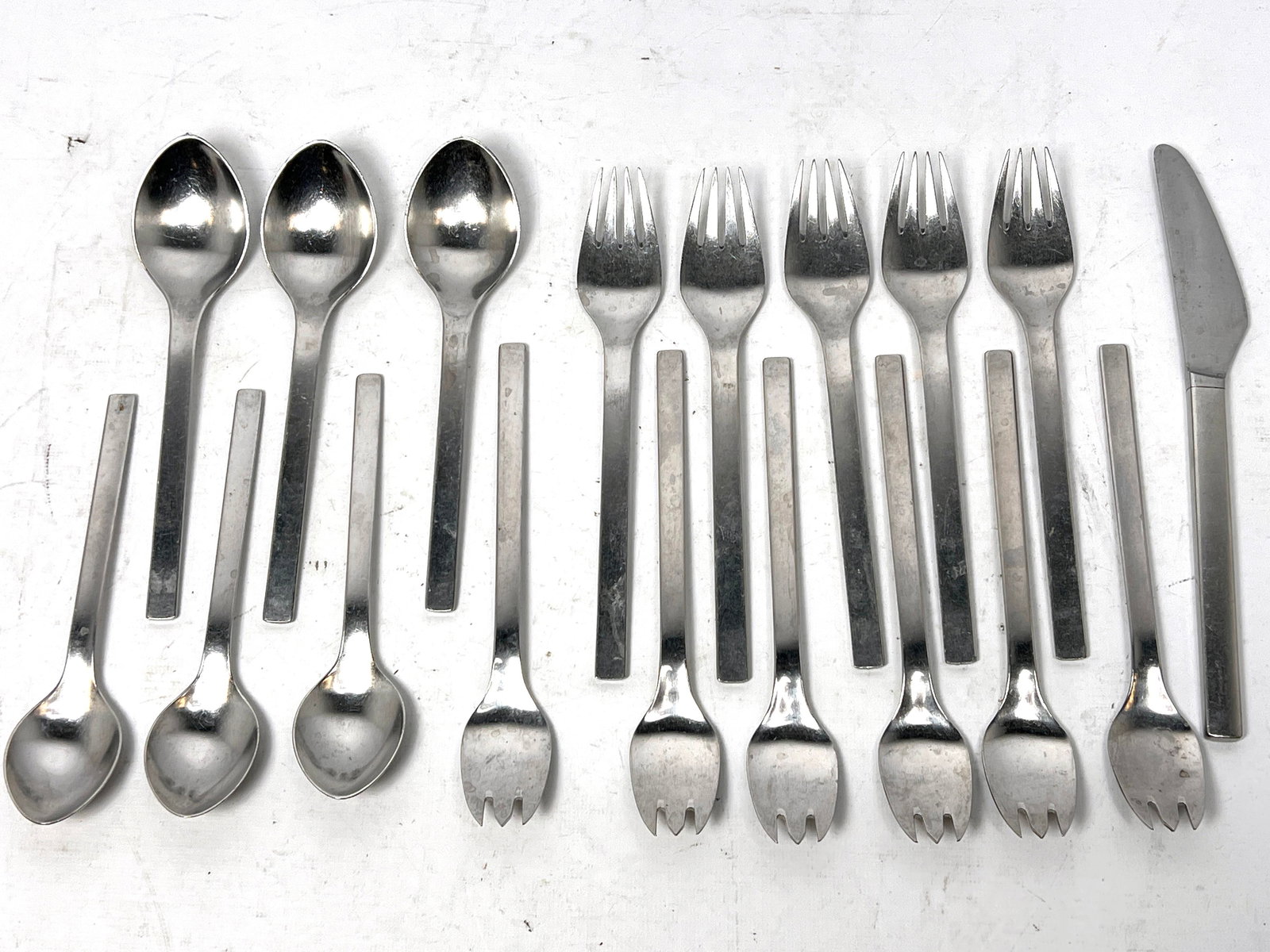 Georg Jensen Tuja - Tanaqvil steel flatware. Designed by Magnus Stephensen pc: Georg Jensen Tuja - Tanaqvil steel flatware. Designed by Magnus Stephensen pc --- US Packing and Shipping charge: $35 Plus insurance at a rate of $1 per hundred. - We offer curbside delivery for most