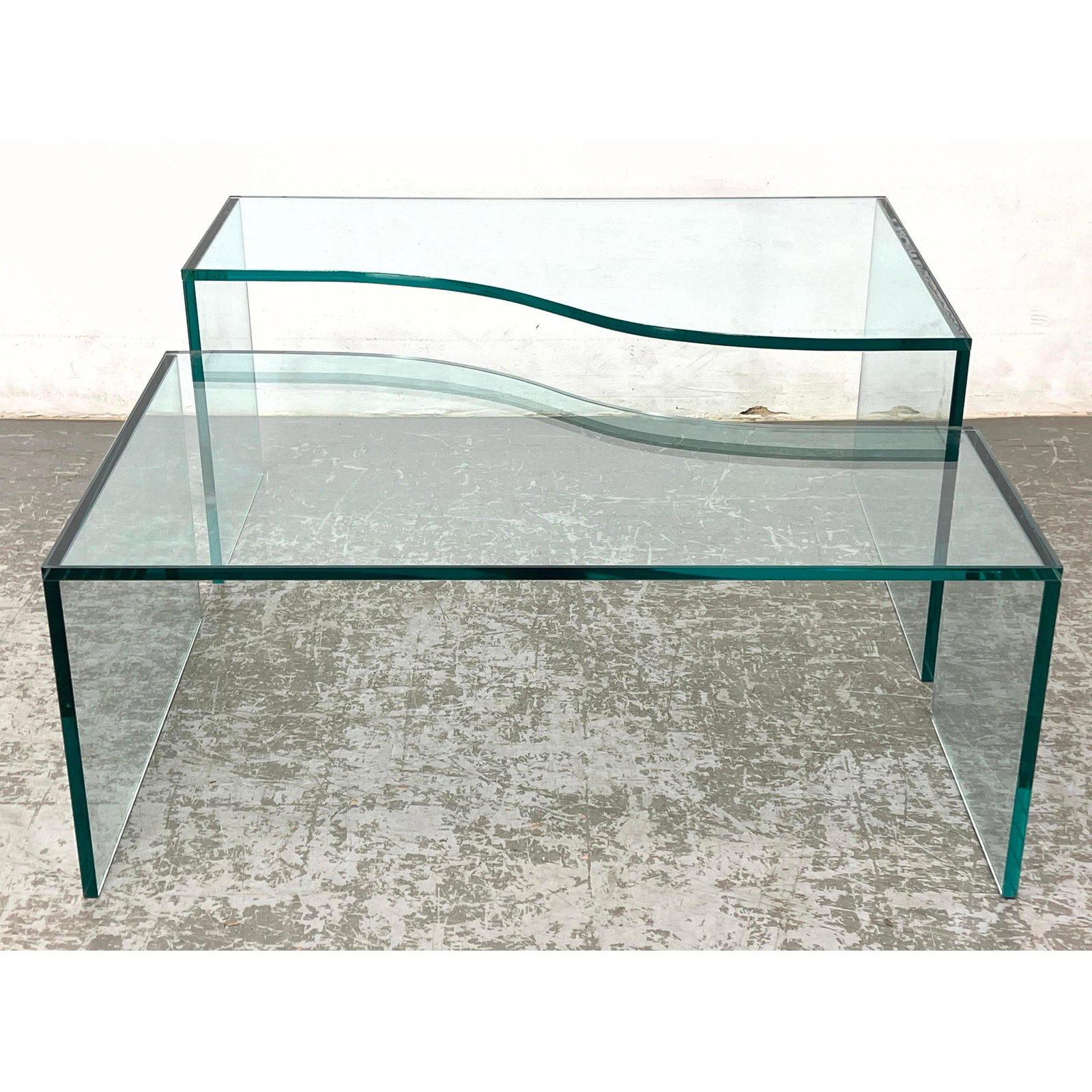 2pc Shaped Top Plate Glass Tables. 2 Different Heights. Thick glass.: 2pc Shaped Top Plate Glass Tables. 2 Different Heights. Thick glass. Dimensions: Height: 15.5 inches, Width: 38 inches, Depth: 24 inches. - Additional Dimensions: Short end H: 15 inches, D: 14 inches 
