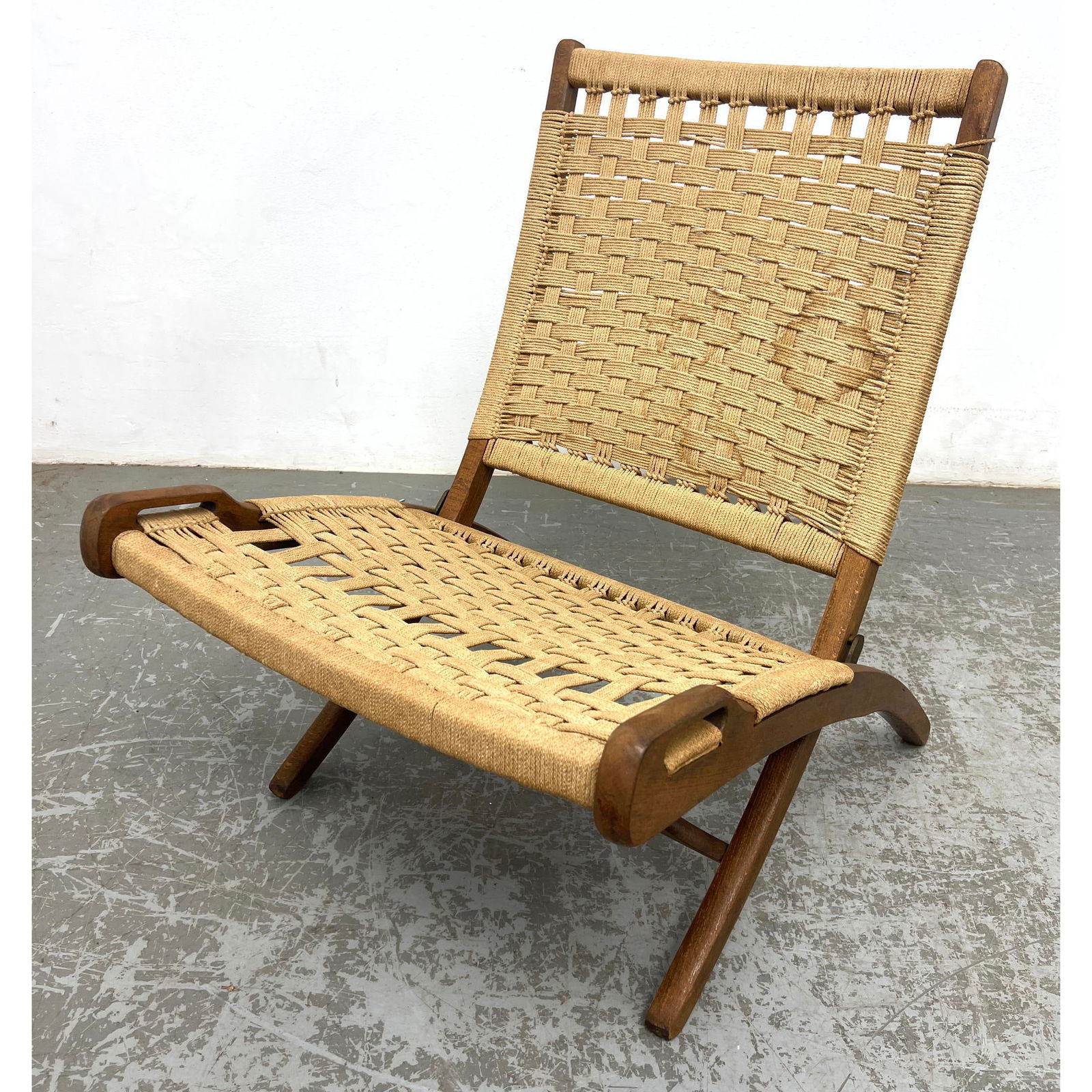 Hans Wegner style Folding Wood Frame Lounge Chair. Woven rush.: Hans Wegner style Folding Wood Frame Lounge Chair. Woven rush. Dimensions: Height: 29 inches, Width: 21 inches, Depth: 30 inches. - Seat Height: 14 inches --- - We offer curbside delivery for most ite