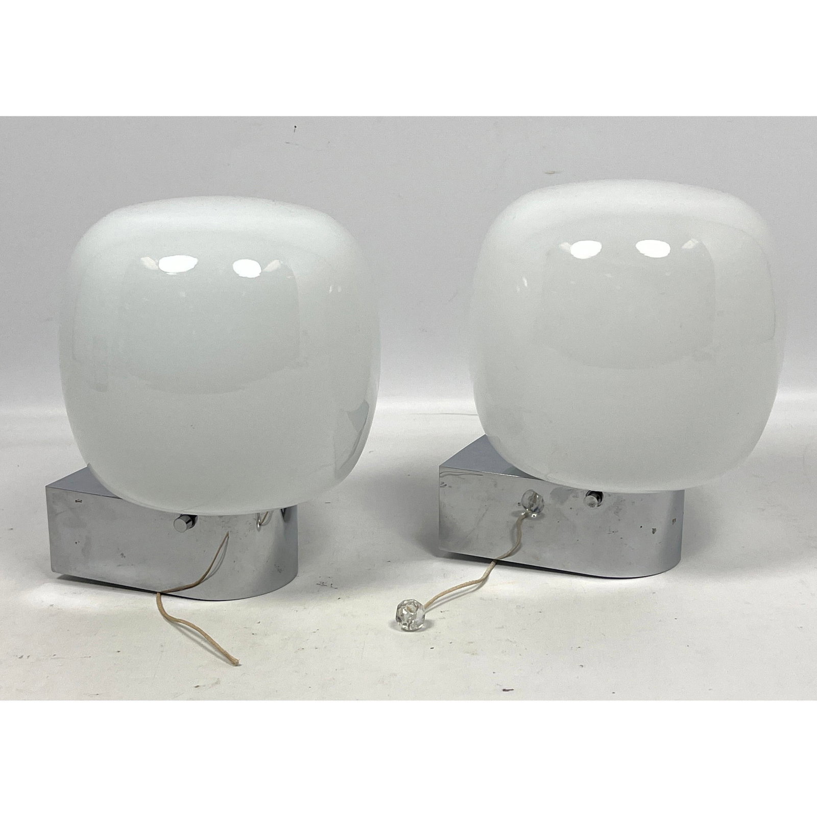 Pair Bauhaus white glass and chrome mounted sconces: Pair Bauhaus white glass and chrome mounted sconces Dimensions: Height: 7.5 inches, Width: 6 inches, Depth: 6 inches. --- US Packing and Shipping charge: In house shipping available. Will be calculate