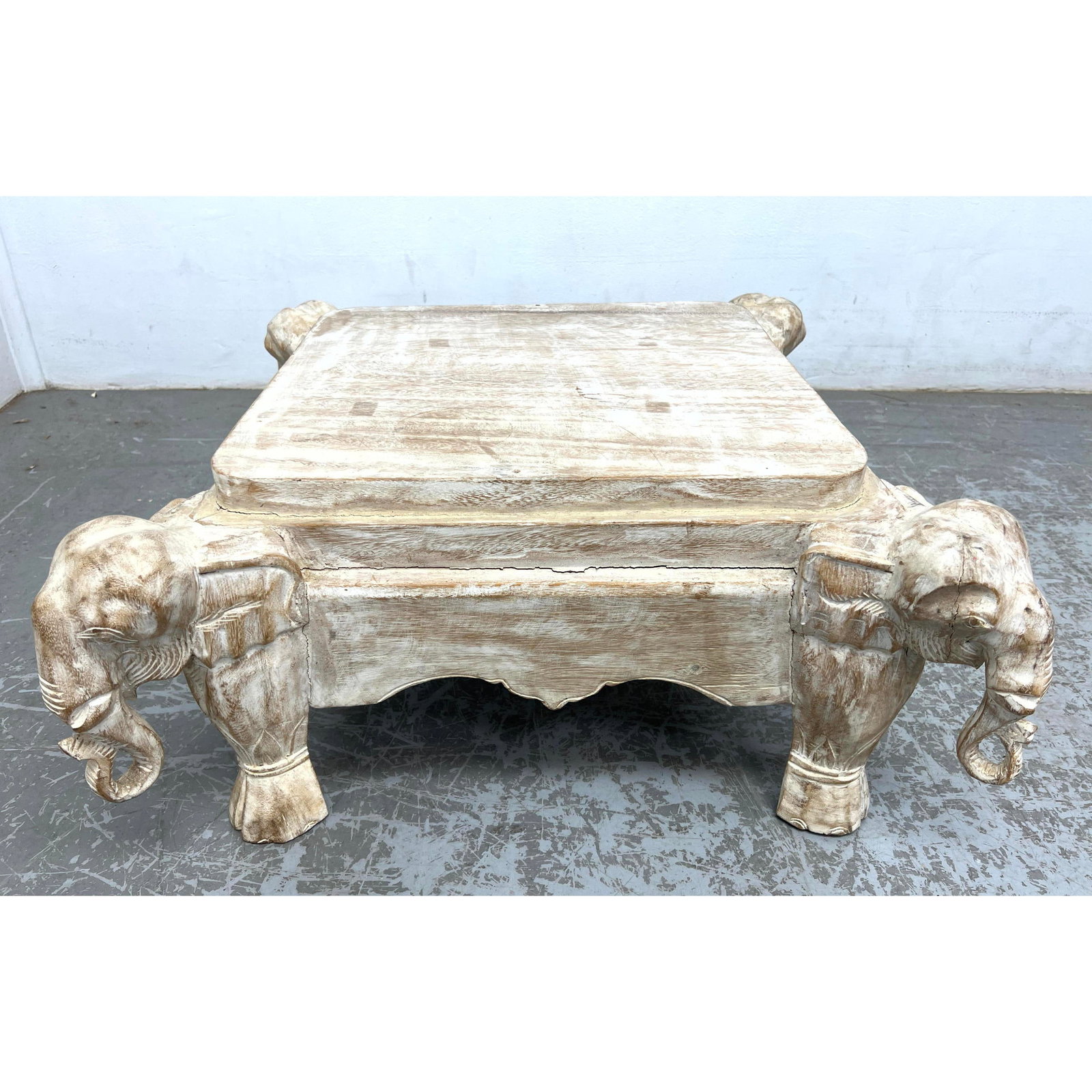 Carved Wood Limed Finish Elephant Head Base Stand. Figural Head Corner Legs.: Carved Wood Limed Finish Elephant Head Base Stand. Figural Head Corner Legs. Dimensions: Height: 12 inches, Width: 27 inches, Depth: 27 inches. --- - We offer curbside delivery for most items to NYC, 