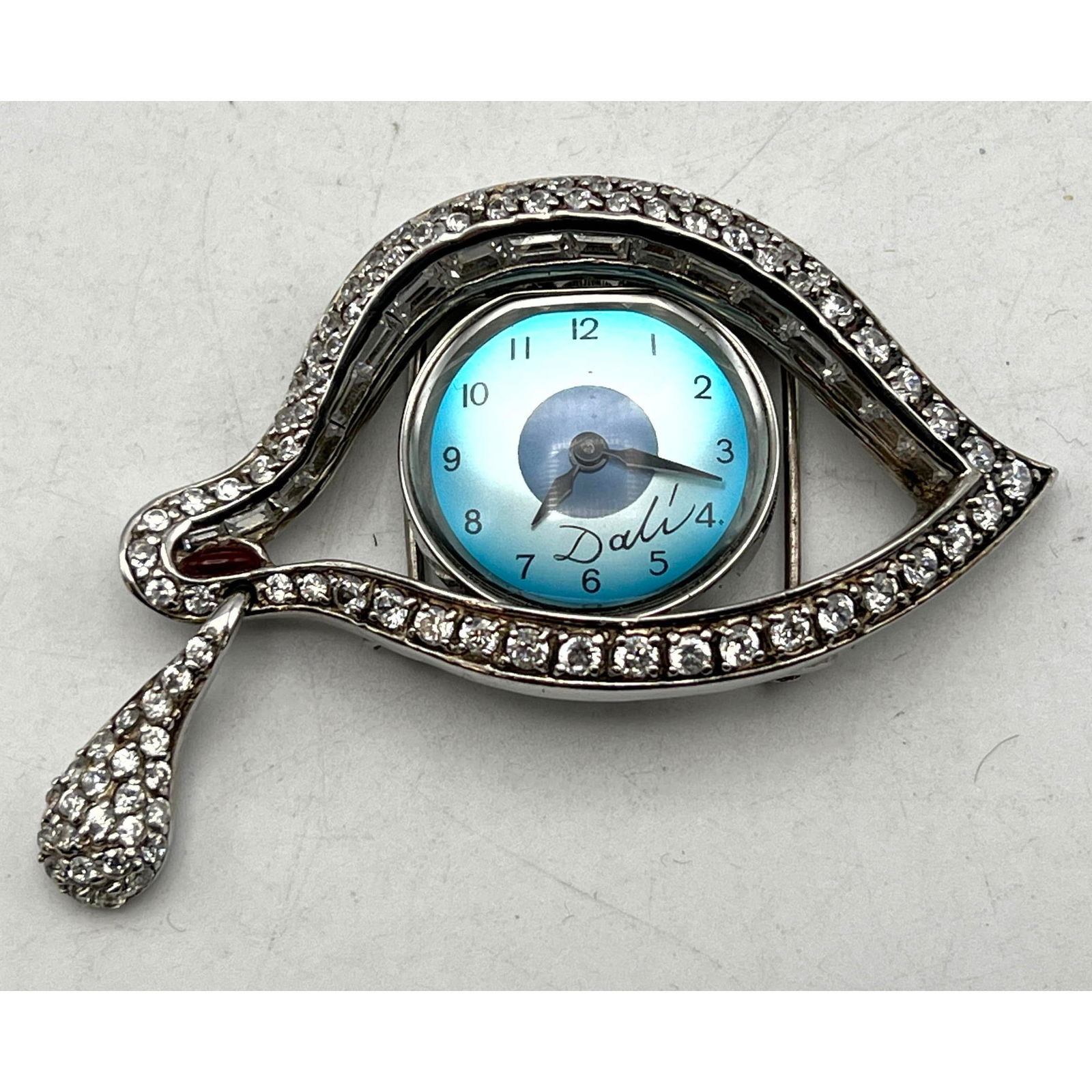 SALVADOR DALI Eye of Time Watch Pin. Master of the Surreal and Avant Garde, Dali created the iconic (1 of 8)