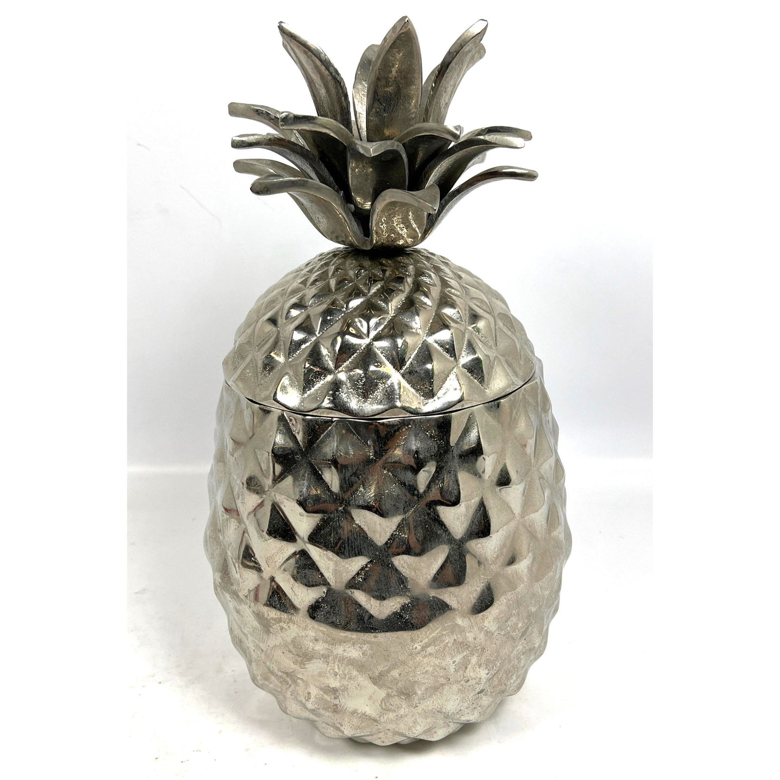 Aluminum Pineapple with opening top. Unsigned. Possibly an ice bucket.: Aluminum Pineapple with opening top. Unsigned. Possibly an ice bucket. Dimensions: Height: 14.5 inches, Width: 7 inches, Depth: 7 inches. --- - We offer curbside delivery for most items to NYC, Manhat