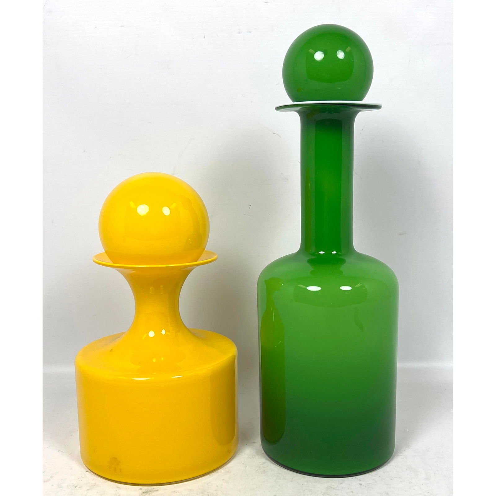 2pc Guulvase by Otto Brauer for Holmegaard Yellow and Green cased glass decanters: 2pc Guulvase by Otto Brauer for Holmegaard Yellow and Green cased glass decanters Dimensions: Height: 15 inches, Width: 5 inches, Depth: 5 inches. - Additional Dimensions: Yellow H: 10 inches --- - We