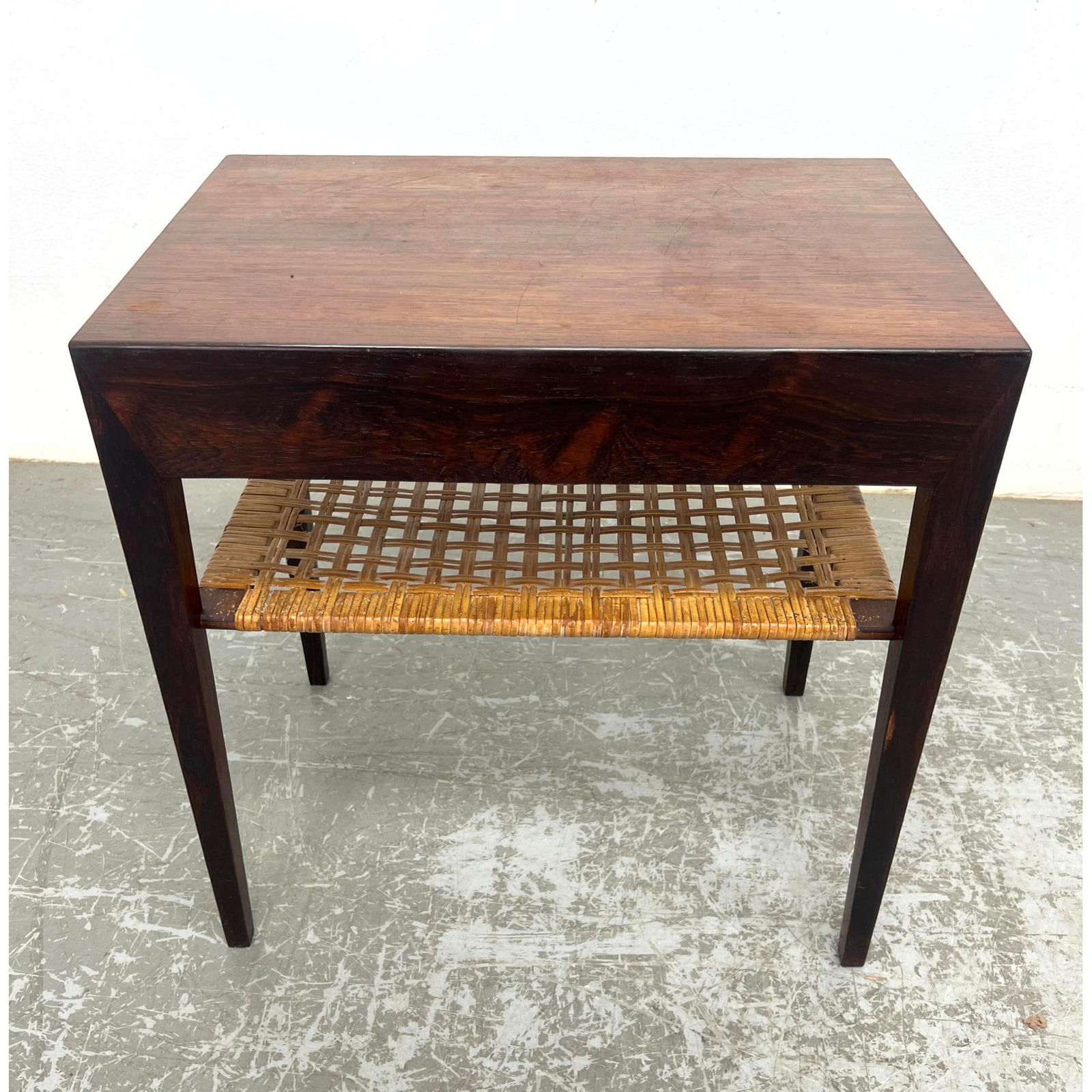 Danish Modern Severin Hansen for Haslev Mobelsnedkeri Rosewood Side End Table with drawer and woven: Danish Modern Severin Hansen for Haslev Mobelsnedkeri Rosewood Side End Table with drawer and woven rattan shelf. Label Dimensions: Height: 19.5 inches, Width: 19.5 inches, Depth: 13.75 inches. --- -