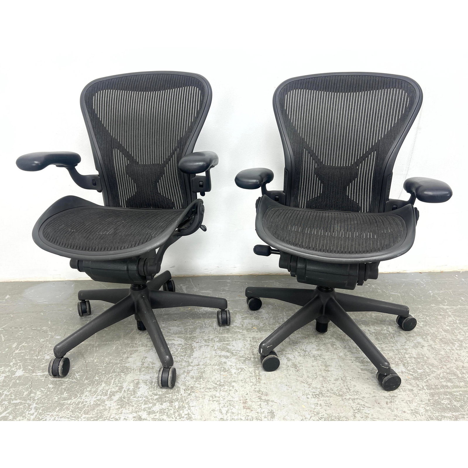 2pc HERMAN MILLER "Aeron" Desk Chairs. Adjustable Heights. Marked. Size B: 2pc HERMAN MILLER "Aeron" Desk Chairs. Adjustable Heights. Marked. Size B Dimensions: Height: 39 inches, Width: 28 inches, Depth: 26 inches. - Seat Height: 18.5 inches ---