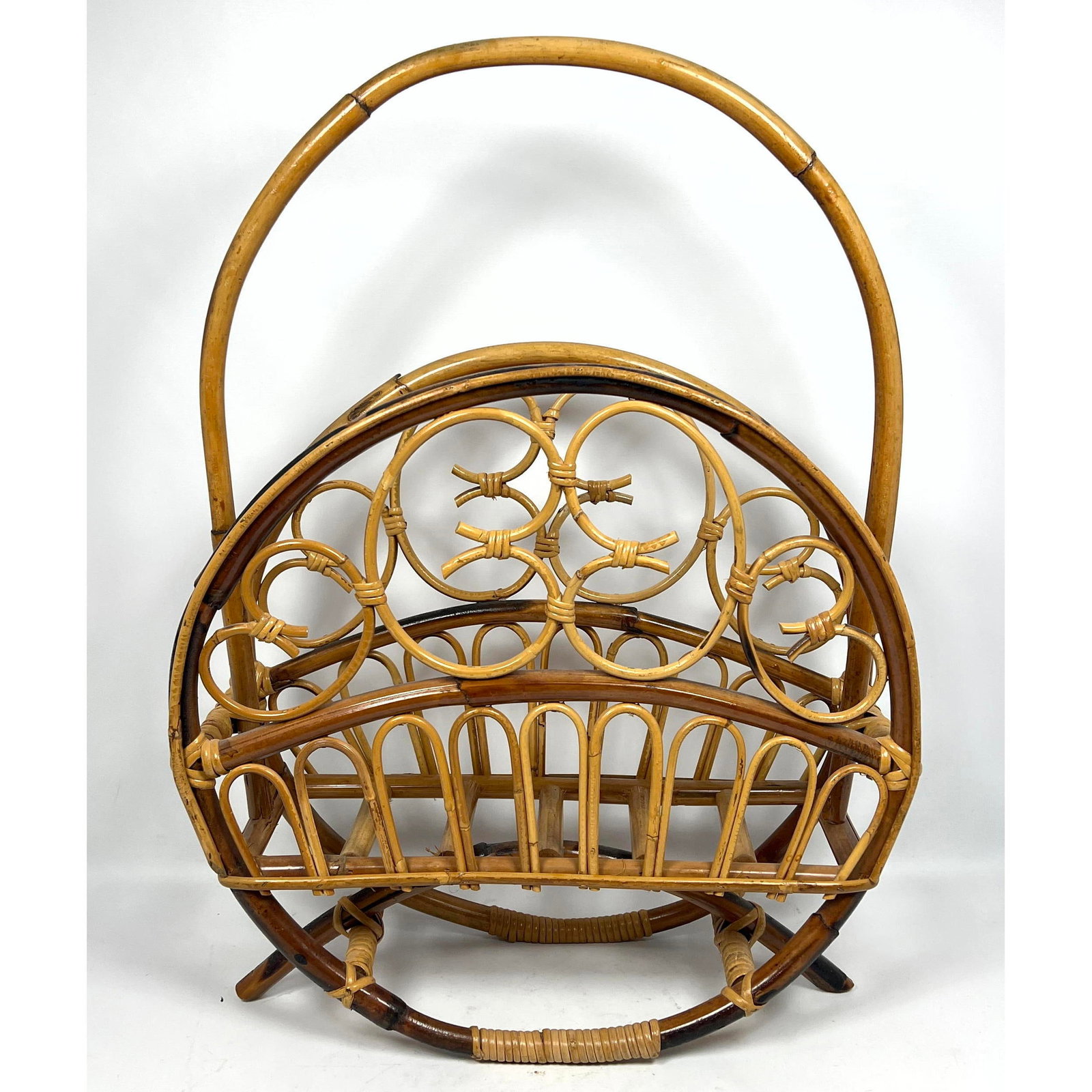 Rattan Magazine Holder. Modernist MCM Hoop form.: Rattan Magazine Holder. Modernist MCM Hoop form. Dimensions: Height: 28 inches, Width: 20.25 inches, Depth: 7 inches. ---