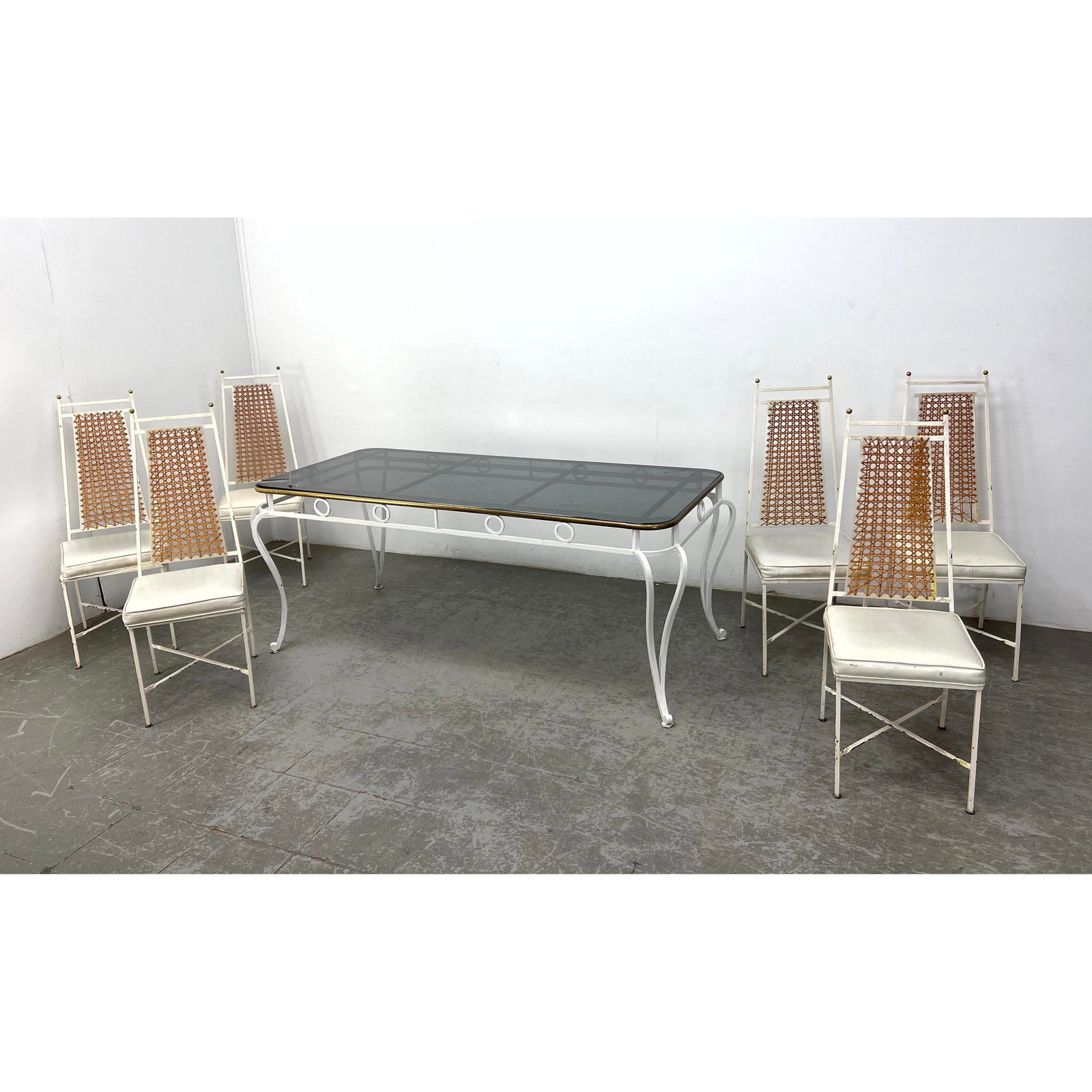 7pc Patio Iron Table and Dining Chairs. Painted White Iron Dining Table with Brass Trim and Smoked G: 7pc Patio Iron Table and Dining Chairs. Painted White Iron Dining Table with Brass Trim and Smoked Glass Top. Set of 6 Tall Caned Back Chairs. Porch Set. Dimensions: Height: 42 inches, Width: 16 inche