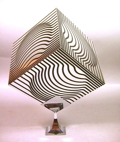VICTOR VASARELY Aluminum Cube OP ART Sculpture: VICTOR VASARELY Aluminum Cube OP ART Sculpture on Chrome Stand. Black & Mirror Finish. Cube spins in stand. Unmarked -- Dimensions: H: 14 inches: W: 7.75 inches --- US Shipping charge: $28