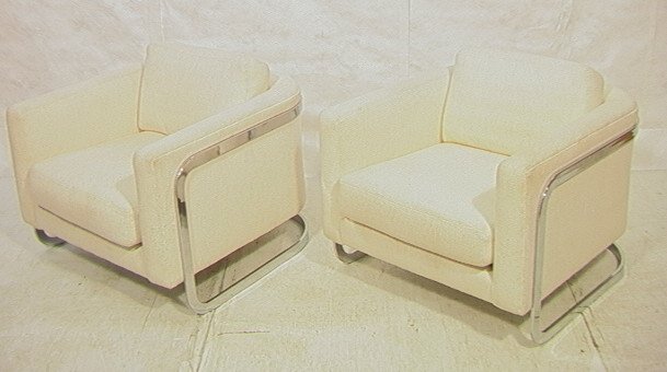 Pr MILO BAUGHMAN style Flat Chrome Lounge Chairs.: Pr MILO BAUGHMAN style Flat Chrome Lounge Chairs. Textured cream upholstery. Bowed chrome side arms. -- Dimensions: H: 26.5 inches: W: 34.5 inches: D: 34 inches ---
