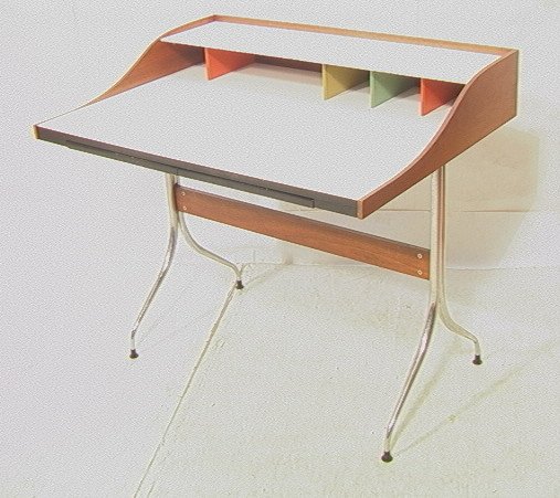 GEORGE NELSON Swag Legged Desk. HERMAN MILLER. Wh: GEORGE NELSON Swag Legged Desk. HERMAN MILLER. Original vintage desk with metal tag. White laminate top on walnut veneer frame. Painted cubby dividers. Chrome legs. Herman Miller metal tag.-- Dimensio