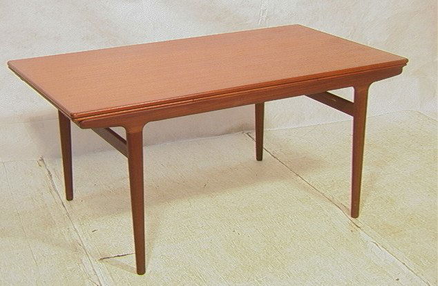 Danish Modern Teak Dining Table. Refractory style: Danish Modern Teak Dining Table. Refractory style top on tapered legs. Angled skirt. Unmarked.-- Dimensions: H: 28.5 inches: D: 35.5 inches: L: 63 inches ---