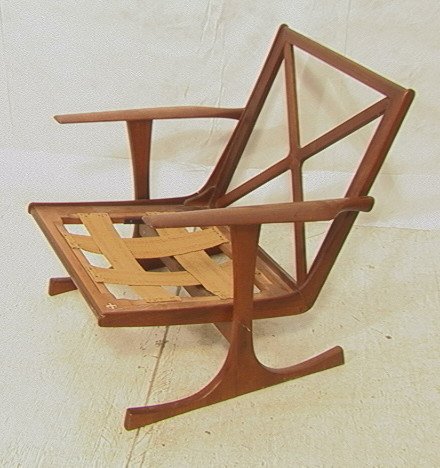SELIG Chair. Danish Modern Teak Lounge Chair. "X": SELIG Chair. Danish Modern Teak Lounge Chair. "X" Back. Flared Legs. Reverse "T" Legs. Red metal tag. -- Dimensions: H: 30 inches: W: 31 inches: D: 29 inches ---