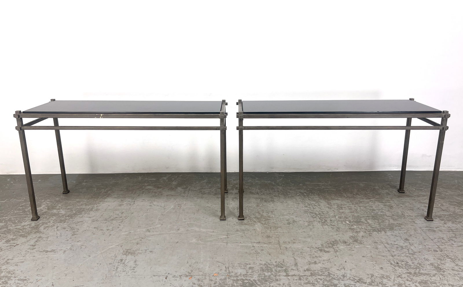 Pair Iron Frame Console Sofa Tables with Inset Black Granite. Painted silver finish.: Pair Iron Frame Console Sofa Tables with Inset Black Granite. Painted silver finish. Dimensions: Height: 29 inches, Width: 50 inches, Depth: 18 inches. --- - We offer curbside delivery for most items