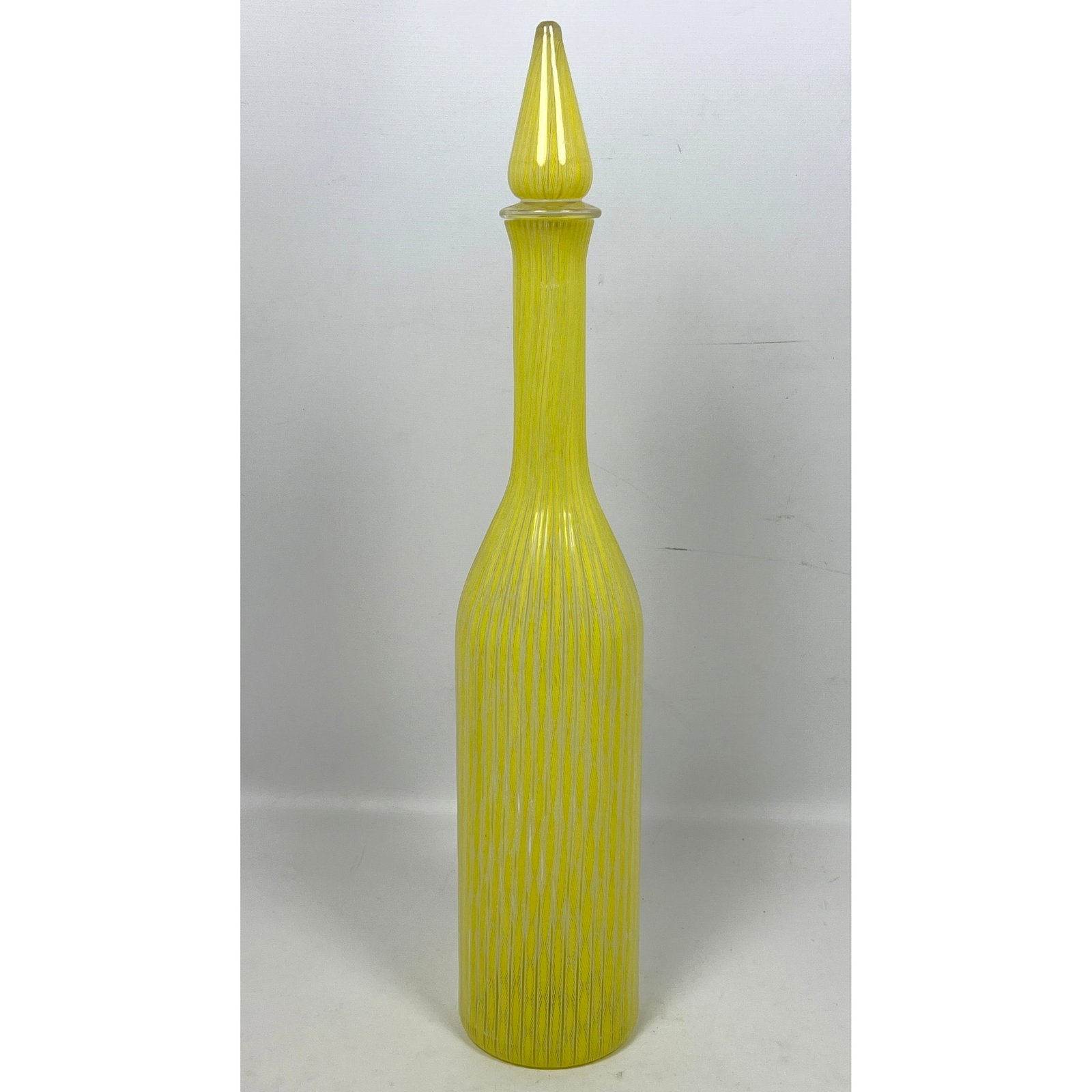 Venetian Murano Italian Art Glass Stoppered Bottle. 18" Tall. Latticino yellow and white design. Ita: Venetian Murano Italian Art Glass Stoppered Bottle. 18" Tall. Latticino yellow and white design. Italy Modernist design. Label. Art Glass. Dimensions: Height: 18.5 inches, Width: 3 inches, Depth: 3 in