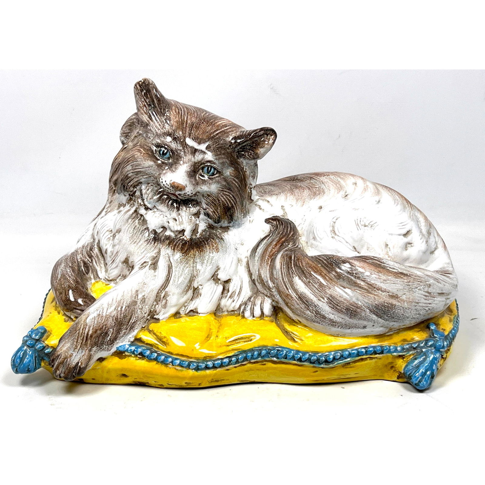 Vintage Italian Glazed Pottery Figural Cat Sculpture. Blue Eyed C at rests on Yellow pillow with Tas: Vintage Italian Glazed Pottery Figural Cat Sculpture. Blue Eyed C at rests on Yellow pillow with Tassels. Marked Italy Dimensions: Height: 10 inches, Width: 15 inches, Depth: 10 inches. --- US Packing