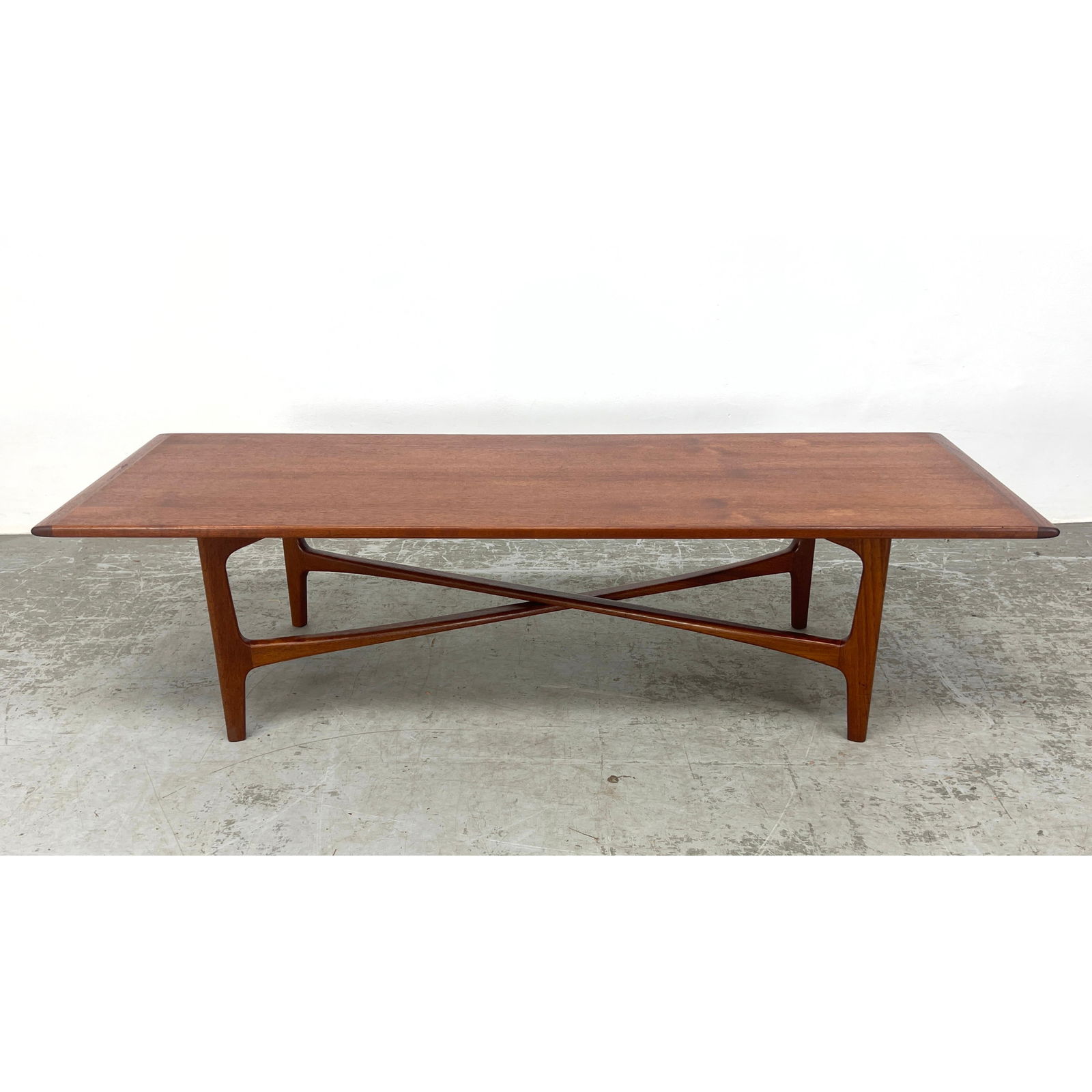 Folke Ohlsson coffee table. Danish Modern Teak Coffee Table has Elegant X Frame Stretchers. Marked: (1 of 8)