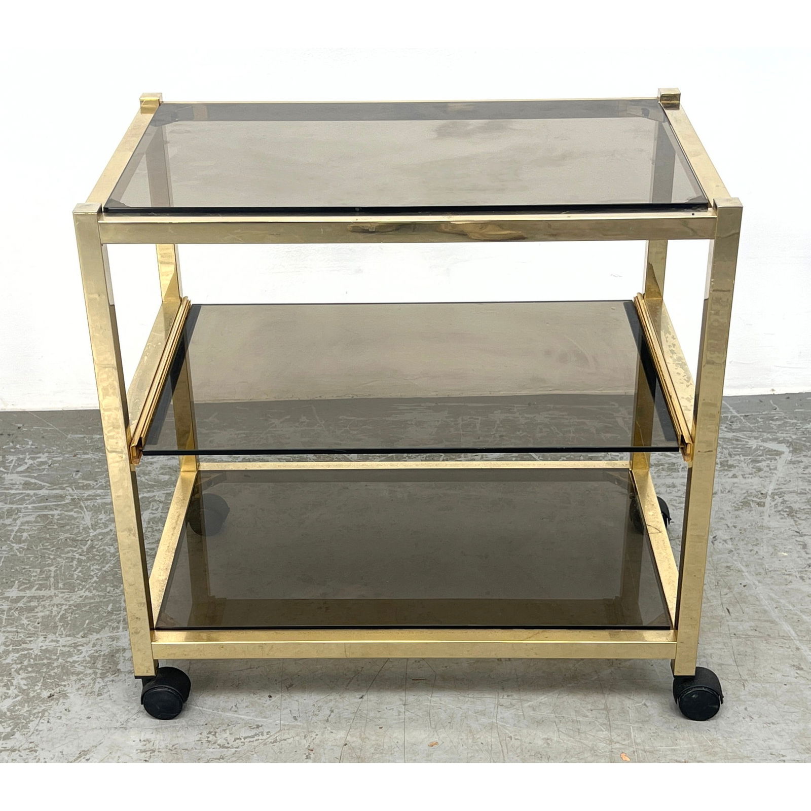 Gold Tone Brass Bar Cart with Gray Glass.: Gold Tone Brass Bar Cart with Gray Glass. Dimensions: Height: 26 inches, Width: 16.5 inches, Depth: 26.5 inches. --- - We offer curbside delivery for most items to NYC, Manhattan, Close Brooklyn, Hobo