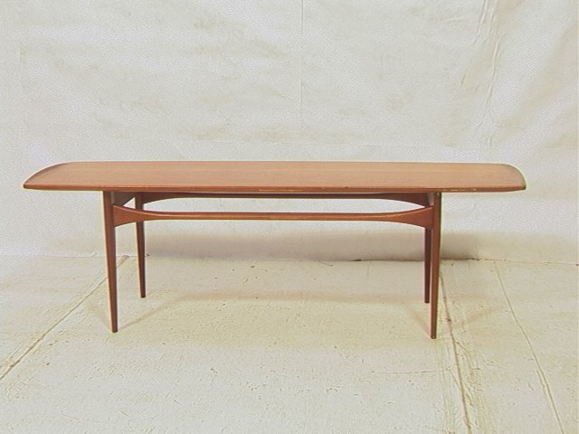 Danish Teak FRANCE & DAVERKOSEN Cocktail Table. M: Danish Teak FRANCE & DAVERKOSEN Cocktail Table. Modern rectangular teak coffee table with raised shaped sides. Tapered peg legs and arched shaped stretchers. Branded mark. Possibly designed by Greta J