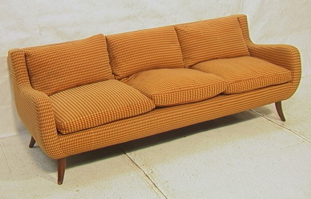 Upholstered Mid Century Sofa Couch. Three Seater: Upholstered Mid Century Sofa Couch. Three Seater in gold & orange diamond pattern fabric. Flared saber legs. Unmarked.-- Dimensions: H: 29 inches: D: 32 inches: L: 81 inches ---