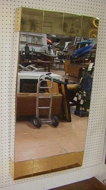 CARL SPRINGER style Wall Mirror. Brass Tile top a: CARL SPRINGER style Wall Mirror. Brass Tile top and bottom trim. Mirror finish acrylic. Unmarked. PAUL EVANS style. -- Dimensions: H: 48 inches: W: 24 inches: D: 4 inches ---