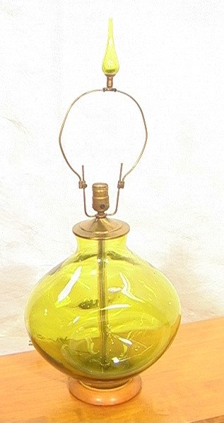 BLENKO Large Green Art Glass Lamp. Dimpled form.: BLENKO Large Green Art Glass Lamp. Dimpled form. Matching glass teardrop finial. Metal fixtures and wood base. Label. -- Dimensions: H: 30.5 inches: W: 12 inches: D: 10 inches ---
