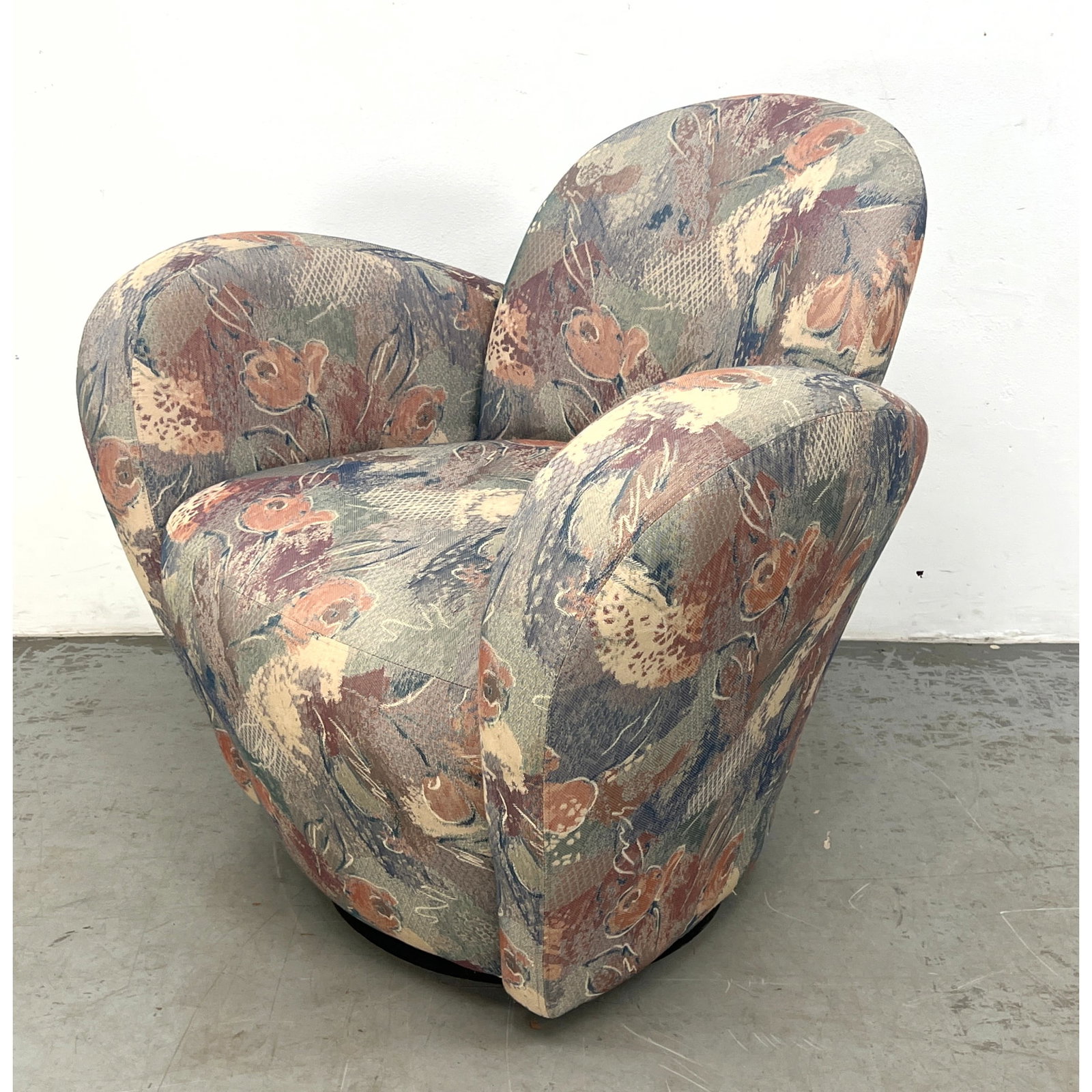 Unusual Design Swivel Arm Lounge Chair. Thick Padded Bowed Arms. Tongue form Backrest. The Backside: Unusual Design Swivel Arm Lounge Chair. Thick Padded Bowed Arms. Tongue form Backrest. The Backside of Chair has dramatic styling. Patterned fabric. Swivels. Dimensions: Height: 32 inches, Width: 33 i
