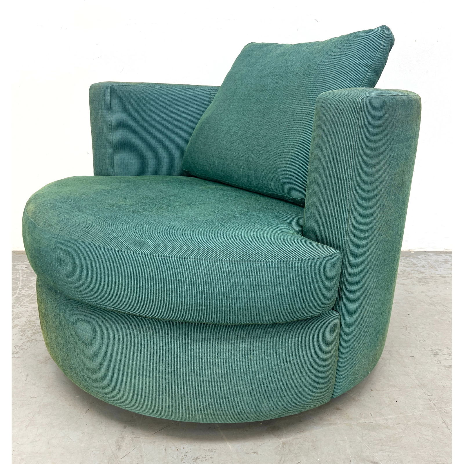 Teal Fabric Upholstered Swivel Lounge Chair. Barrel Back with Curved Front seat cushion. Label: Amer: Teal Fabric Upholstered Swivel Lounge Chair. Barrel Back with Curved Front seat cushion. Label: American Leather. Dimensions: Height: 28 inches, Width: 36 inches, Depth: 36 inches. - Seat Height: 18 i