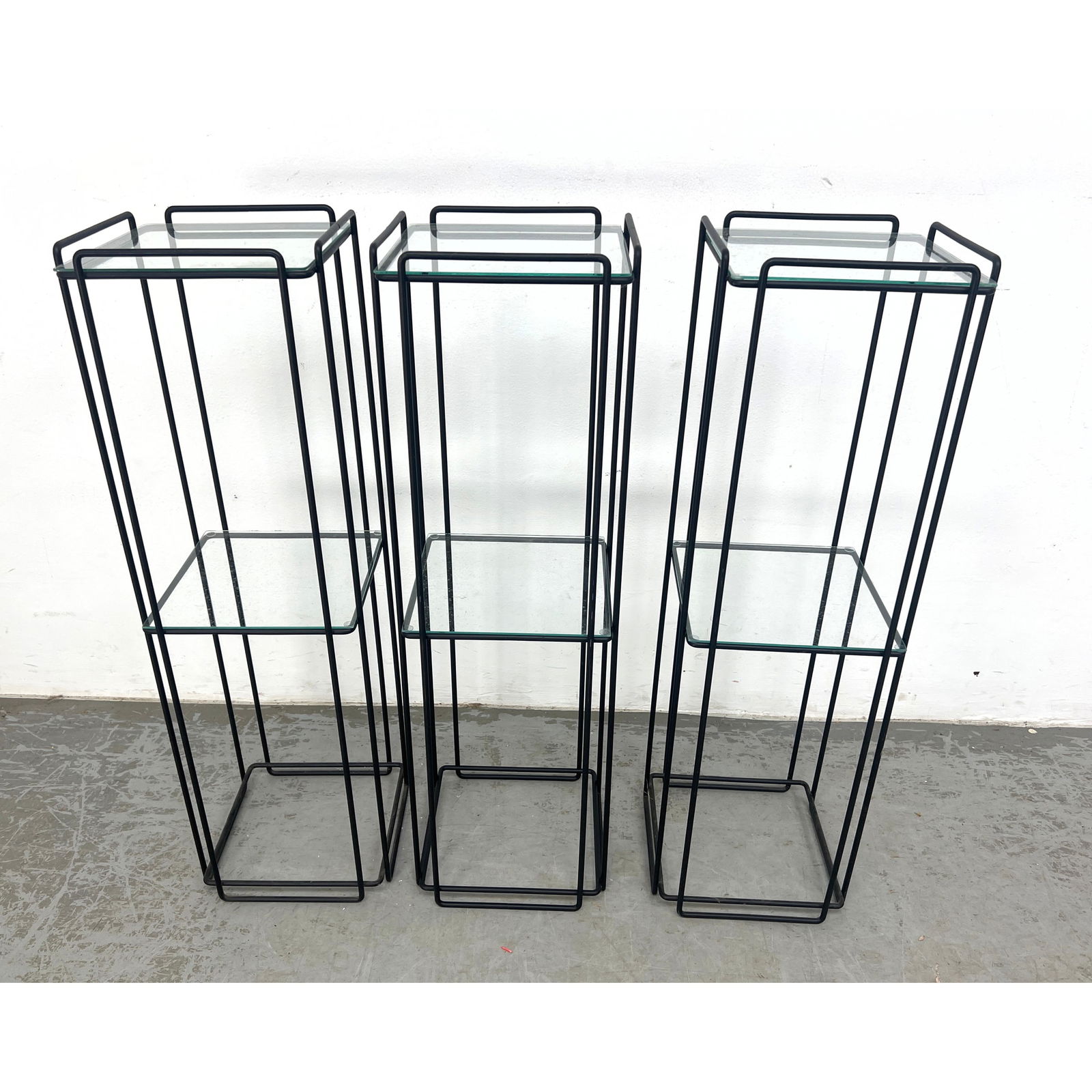 3pc MAX SAUZE Black Metal Frame Tall Display Pedestals. Isoceles Model with Glass Top and Shelf. MCM: 3pc MAX SAUZE Black Metal Frame Tall Display Pedestals. Isoceles Model with Glass Top and Shelf. MCM Design. Dimensions: Height: 36 inches, Width: 11 inches, Depth: 11 inches. --- - We offer curbside